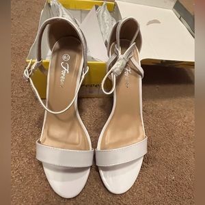 Size 6.5 white heels in box.